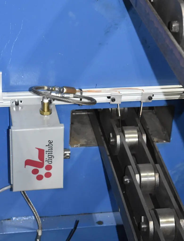 dual strand lubricator, shooting lubricant on chain pins on a CC9 conveyor